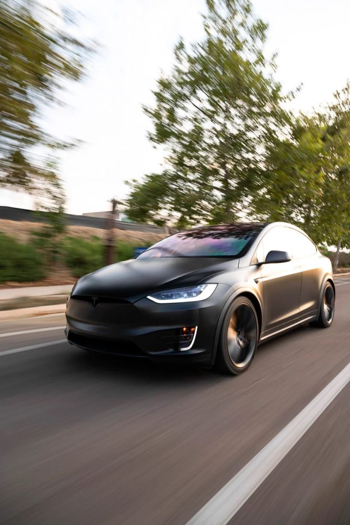 black matte car at speed on the road