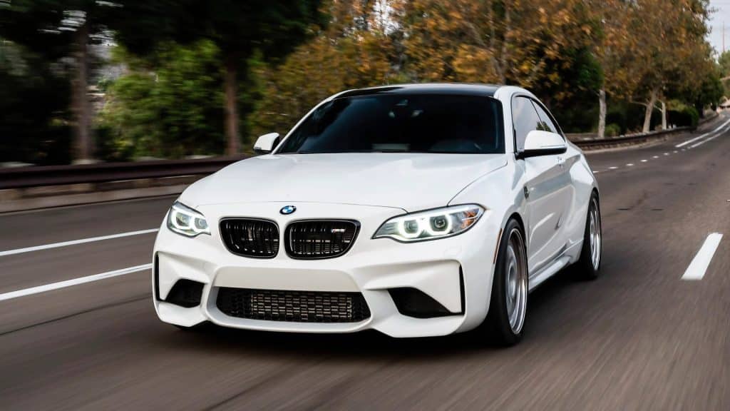 white bmw on the road at speed
