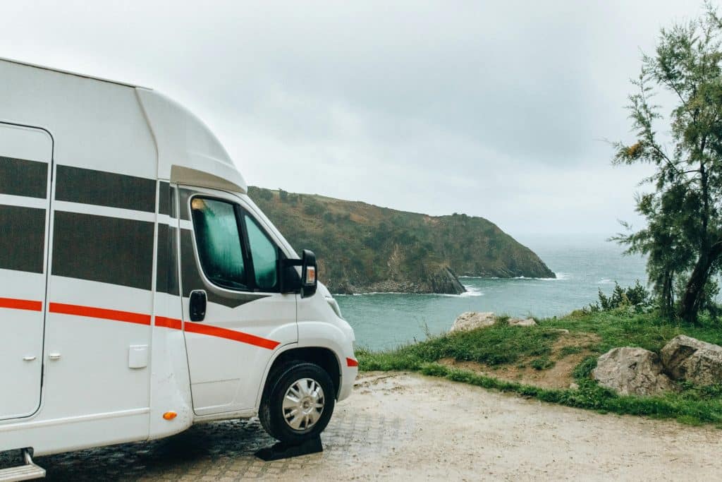rv parked near a cliff by the ocean